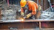 © Jiraphat - A construction worker welding steel beams at a job site, showcasing skilled craftsmanship and safety precautions.