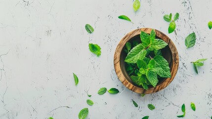 Sticker - Fresh mint leaves in a wooden bowl on a white, textured surface, symbolizing natural freshness and herbal simplicity.