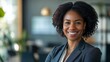 © Snowstudio - attractive black businesswoman standing in modern office