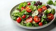 © The prominence - A fresh green salad with assorted veggies on a white plate, isolated on white