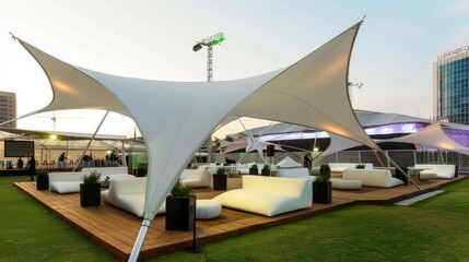 Modern white canopy tent provides shade over outdoor seating area.