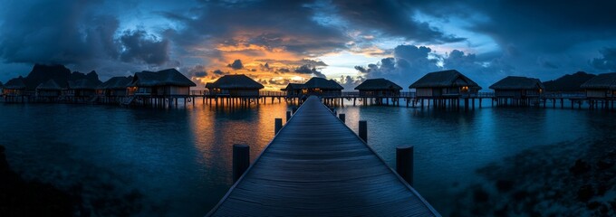 At sunset, overwater bungalows at a luxurious beach resort