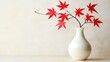 © ElenaX - Elegant red maple leaves in white vase on neutral background