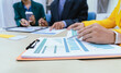 © Witoon - A busy office environment where teams collaborate on creative projects, finance, and marketing strategies using data, charts, and reports, engaging in brainstorming and training sessions to achieve bu