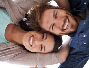 Poster - Happy couple, portrait and hug with love below for support, care or bonding together in nature. Low angle of young man and woman with smile in happiness for embrace, relationship or outdoor holiday