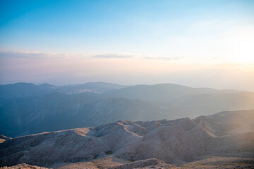 Silhouettes of mountains in a beautiful gentle haze, mountains at sunset or sunrise, natural background