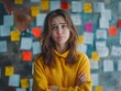 © Bussakon - Pensive Young Woman in Yellow Sweater Amid Colorful Sticky Notes in Sentiment Analysis Concept