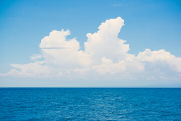 Wall Mural - Blue sky with fluffy cloud in sea background