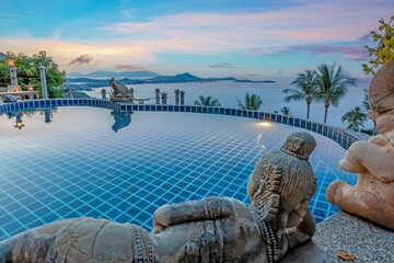 view over an infinity pool on a slope above a tropical beach