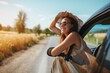 © Pete - Relaxed happy woman on a summer road trip leaning out of car window. Carefree expression, curly hair blowing in the wind. Scenic landscape background with fields and sunset.