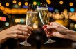© Bundi - A restaurant and cafe with two glasses of sparkling champagne in hands, concept for holidays, weddings, valentines days, Christmas and New Year.