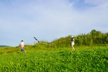 Father and kids playing in the meadow