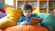 © AiAbstract - Happy Preschool Boy Reading Picture Book on Colorful Pillow in Cozy Nook