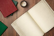 © Solesto - Open empty notebook in vintage style with books on wooden background from above. Flat lay, top view. Copy space