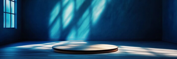 Sticker - A minimalist blue room with a circular platform illuminated by natural light streaming through a window. The platform is positioned on the wooden floor, with light patterns casting shadows around it.