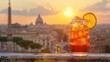 © FryArt - Enjoying a classic spritz cocktail at sunset with the stunning city of Rome as the backdrop