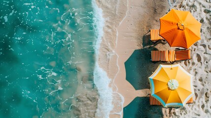 Yellow beach umbrella on sandy coast near sea, top view