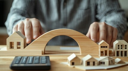 A person builds a wooden bridge with small houses in a creative workspace. The scene reflects architectural design and planning. A calculator shows careful calculations. AI