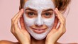 © Oleg - Woman applying a rejuvenating face mask for effective skin care and beauty self care routine