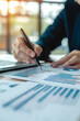© Renata Hamuda - vertical close up of Businessman Analyzing Financial Charts and Data on Desk in Office