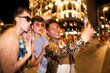 © ADDICTIVE STOCK - LGBTQIA+ friends capturing joyous night with a lively group selfie