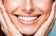 © GTNA73 - Woman's smile white teeth beautiful skin tone and hands. Teeth healthcare concept. Pastel blue background. Closeup.