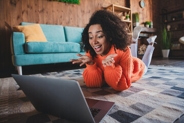 Wall Mural - Photo of shiny impressed girl dressed orange pullover staying home online shopping modern device indoors house apartment room