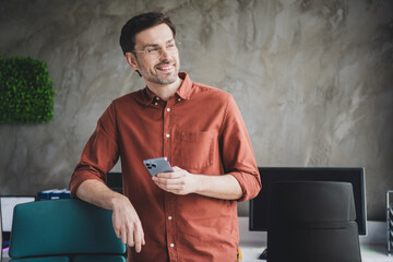 Sticker - Photo of handsome man hold device look empty space coworking successful businessman wear brown formalwear nice creative light office