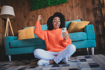 Sticker - Photo of shiny lucky girl dressed orange pullover staying home winning game modern device indoors house apartment room