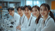 © aekkorn - group of smiling Asian male doctors and smiling Asian female doctors sitting together.