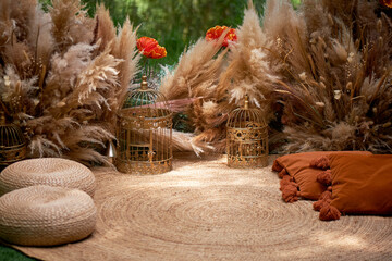 Pillows, pampas, outdoor garden d cor. Wedding decoration in natural materials and warm colors.