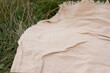 © Maryna - Rumpled linen milky blanket on the grass