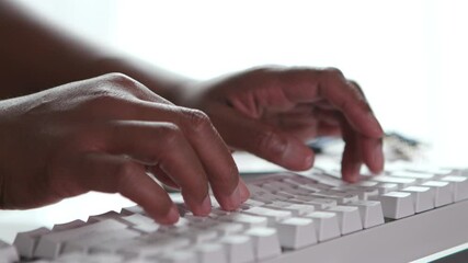 Hands typing on a computer 