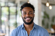 © saida - Cheerful handsome young African man head shot front portrait. Happy positive attractive male entrepreneur, startup leader, business professional in casual looking at camera with toothy smile
