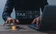 © jimbophotoart - Hand young man uses smaetphone and laptop for Signing tax online, Offers online tax refund forms for paying taxes, Submitting tax forms online, Managing taxes via the internet network