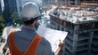 © นิพนธ์ บุญโปร่ง - A construction worker in a hard hat reviewing plans, with a building framework rising in the background, construction site, project development