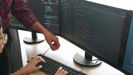 Slow motion back end or software developer manager supervising his team on new application program development on debugging and solving complex code algorithms on monitor. Burgeoning