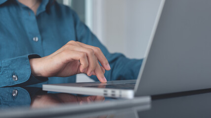 Sticker - Close up, business woman working on laptop computer,  searching the information, surfing the internet with digital tablet on table. Woman hands typing on laptop, online working