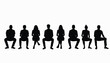 © umut hasanoglu - Silhouette of a diverse group of people sitting on chairs in a row against a white background.