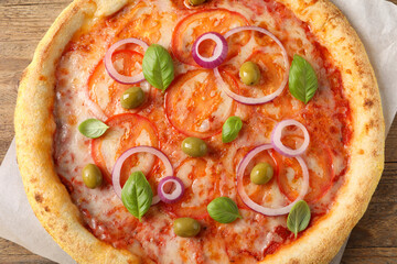 Delicious vegetarian pizza on wooden table, top view