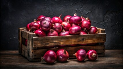 Fresh red onions in wooden crate on black background, showcasing vibrant color and natural texture