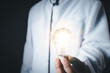© PRIM - Doctor or scientist holding a light bulb showing a new idea creative research concept on virus protection, Doctor showing idea gear engineering bulb virtual healthcare network, creative research.