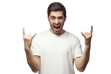 Young man showing rock gesture with his fingers as if listening to favourite music