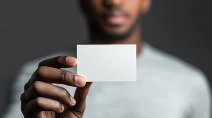 Close-up of a Hand Holding a Blank Business Card