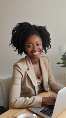 Wall Mural - A woman with curly hair is sitting at a desk with a laptop and a cup of coffee