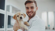 © hayley - a veterinarian confidently holding a puppy in their arms