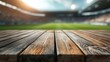 © BerkahStock - Wooden Tabletop with Stadium Background