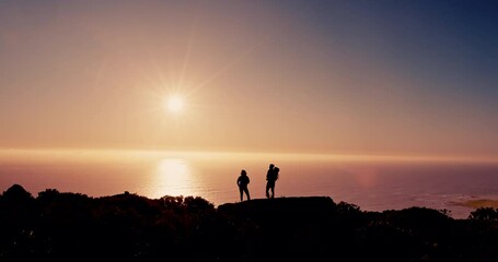 Wall Mural - Couple, silhouette and hiking on mountain at sunset with ocean, sky and mockup space on vacation in summer. People, outdoor and together on hill with view, sea or horizon with trekking in New Zealand