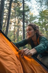 Poster - Woman sets up tent in woods