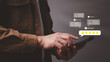 © TimmyTimTim - Online customer service satisfaction Survey and quality of service concept, man using smartphone to give five stars excellent user experience feedback review with other various opinion review.